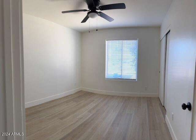 unfurnished room with light wood-type flooring and ceiling fan