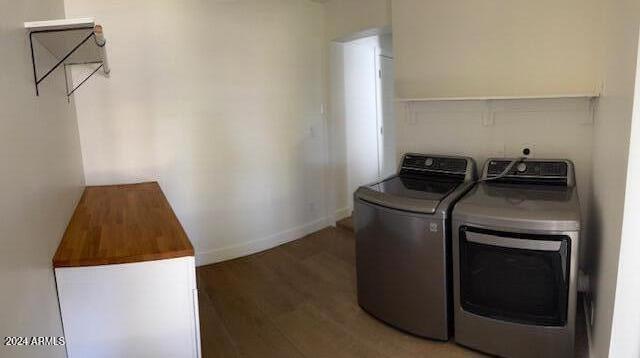 washroom featuring dark wood-type flooring and independent washer and dryer