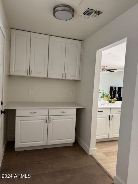 kitchen with white cabinetry, a chandelier, and dark hardwood / wood-style floors