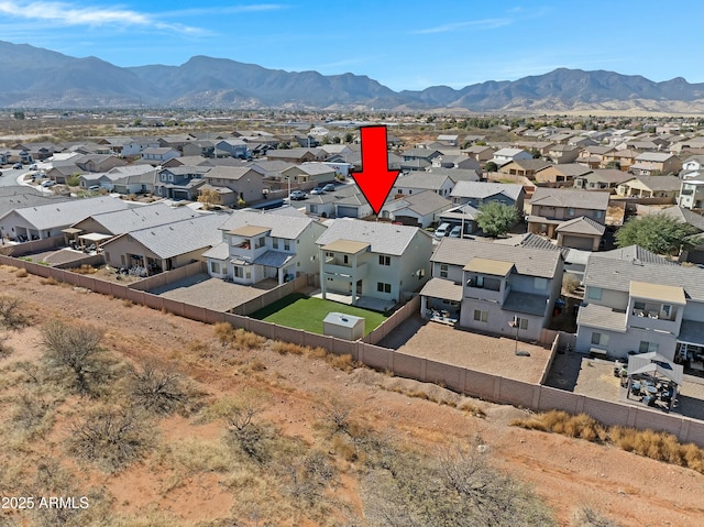 birds eye view of property with a mountain view