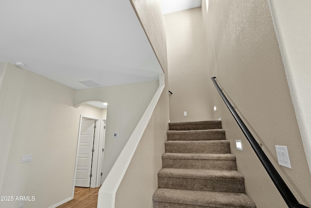 stairs featuring hardwood / wood-style flooring