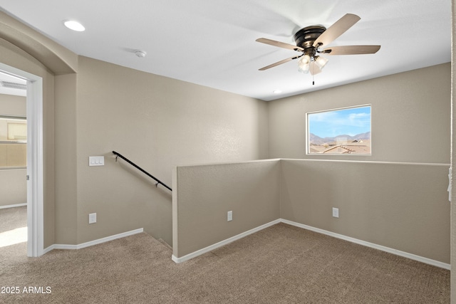 empty room featuring ceiling fan and carpet floors