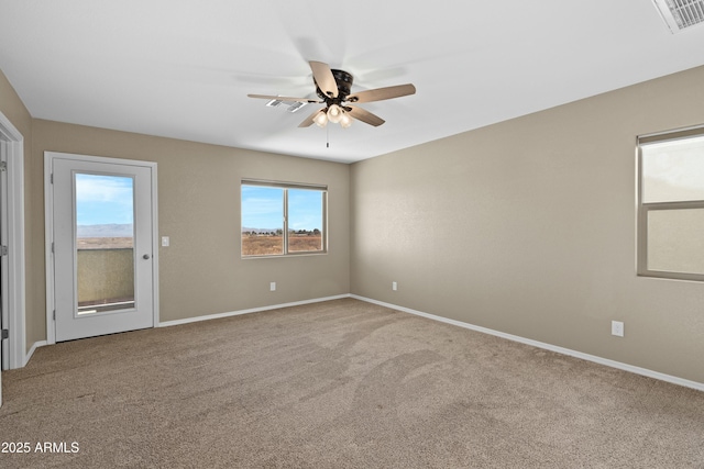 unfurnished room with carpet flooring and ceiling fan