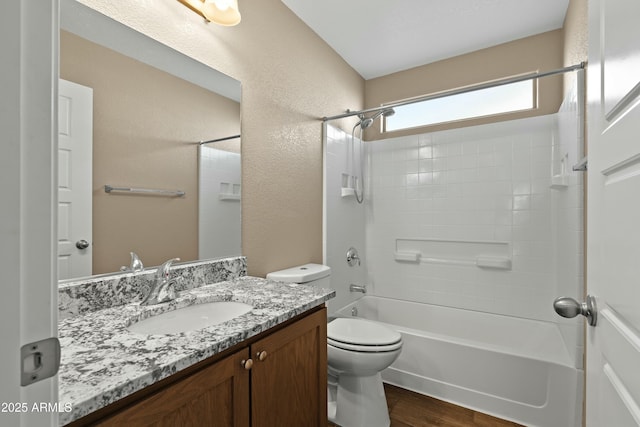 full bathroom with vanity, hardwood / wood-style floors,  shower combination, and toilet