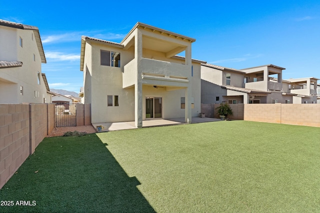 back of property featuring a yard and a patio