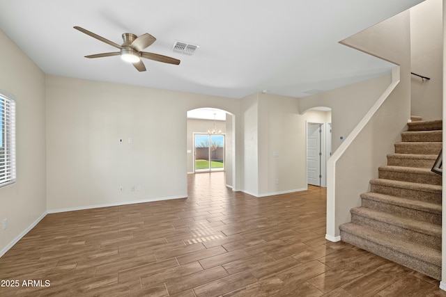 interior space with ceiling fan with notable chandelier