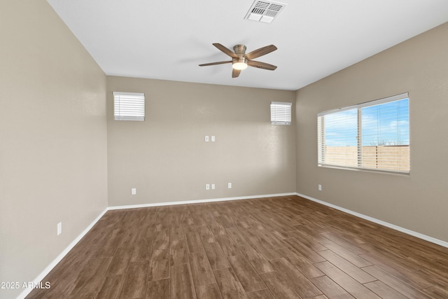 unfurnished room with dark hardwood / wood-style flooring and ceiling fan