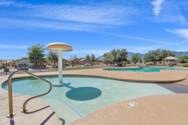 view of pool with a mountain view and a patio