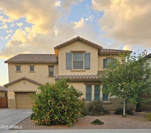 42160 W Arvada Ct, Maricopa, AZ 85138 - mediterranean / spanish-style home featuring a tiled roof, stucco siding, concrete driveway, and an attached garage