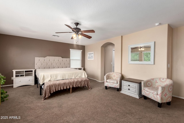 42160 W Arvada Ct, Maricopa, AZ 85138 - carpeted bedroom featuring multiple windows, arched walkways, ceiling fan, and baseboards