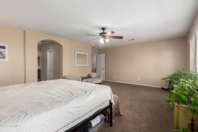 42160 W Arvada Ct, Maricopa, AZ 85138 - bedroom featuring arched walkways, dark colored carpet, baseboards, and ceiling fan