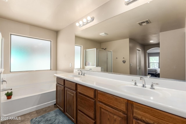 42160 W Arvada Ct, Maricopa, AZ 85138 - ensuite bathroom with a garden tub, double vanity, a stall shower, and tile patterned floors