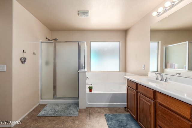 42160 W Arvada Ct, Maricopa, AZ 85138 - bathroom with vanity, a stall shower, a garden tub, and tile patterned flooring