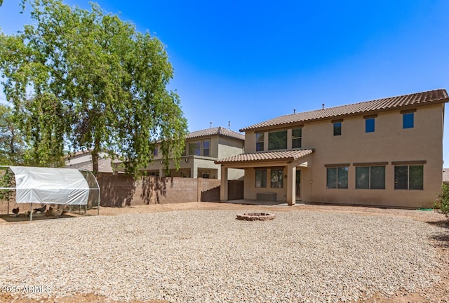 42160 W Arvada Ct, Maricopa, AZ 85138 - rear view of house with a fire pit, stucco siding, a tiled roof, a patio area, and an outdoor structure