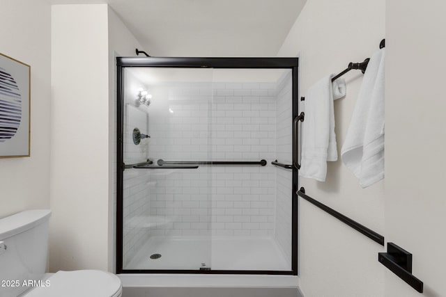 bathroom with toilet and a stall shower
