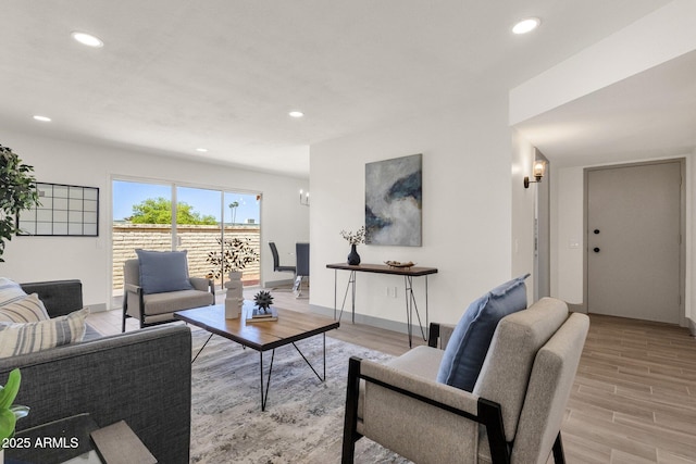 living room with baseboards, recessed lighting, and light wood finished floors