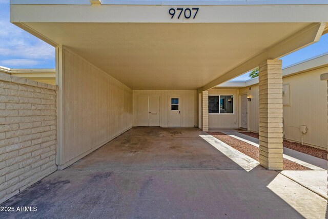 entrance to property with fence and an attached carport