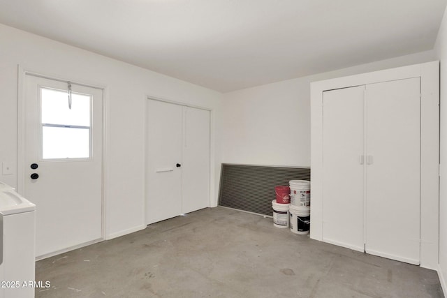 interior space featuring washer / clothes dryer and unfinished concrete floors