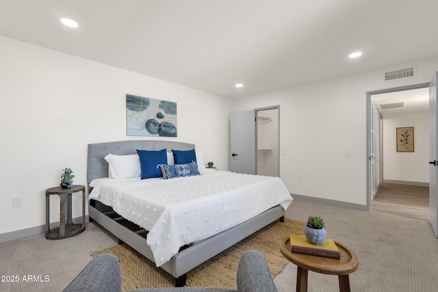 bedroom featuring recessed lighting, visible vents, light carpet, and baseboards