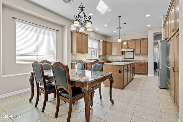 211 W New Dawn Dr, Chandler, AZ 85248 - dining space with light tile patterned flooring, recessed lighting, a chandelier, and baseboards