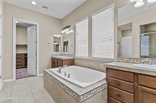211 W New Dawn Dr, Chandler, AZ 85248 - bathroom with a stall shower, two vanities, a garden tub, tile patterned flooring, and baseboards
