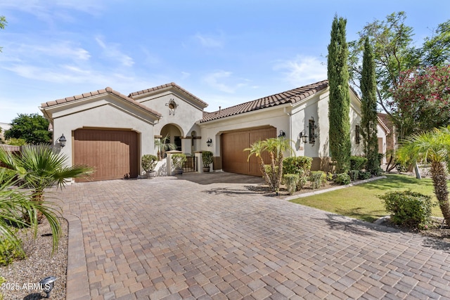 211 W New Dawn Dr, Chandler, AZ 85248 - mediterranean / spanish-style home with a garage, decorative driveway, a tiled roof, and stucco siding