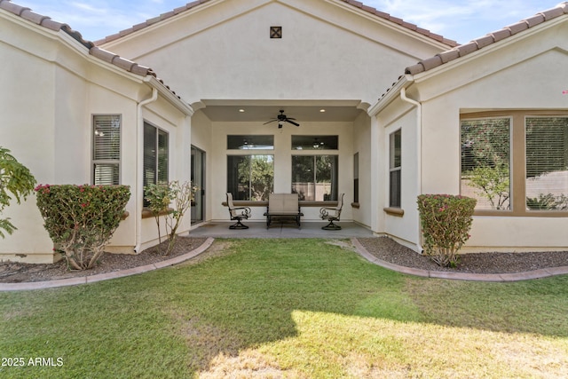 211 W New Dawn Dr, Chandler, AZ 85248 - back of house featuring a ceiling fan, a yard, stucco siding, a tiled roof, and a patio