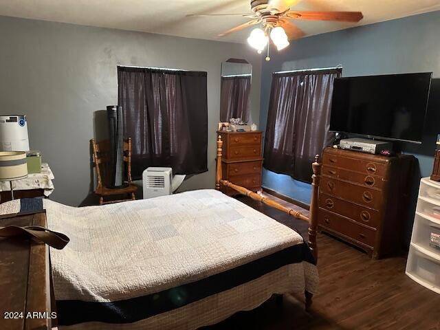 bedroom with dark wood-type flooring and ceiling fan