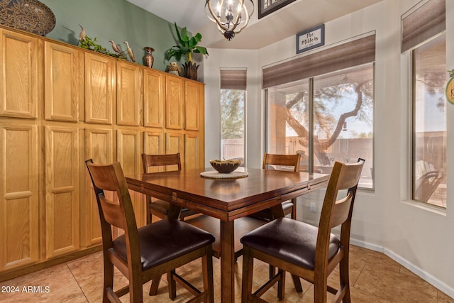 dining area with a chandelier and light tile patterned flooring