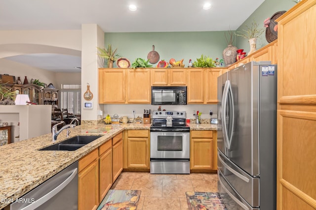 kitchen with light brown cabinets, sink, and stainless steel appliances