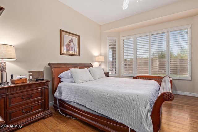 bedroom featuring lofted ceiling and light wood-type flooring