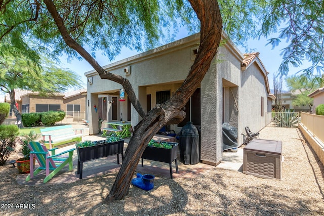 back of property with a patio