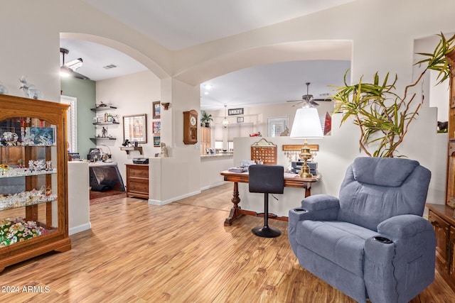 living area with ceiling fan and light wood-type flooring