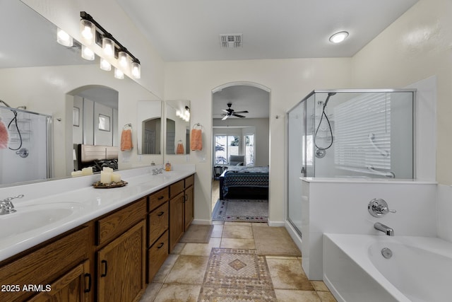 ensuite bathroom with double vanity, visible vents, a stall shower, a sink, and ensuite bath