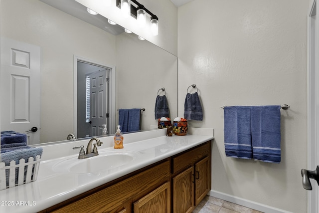 bathroom featuring tile patterned flooring, baseboards, and vanity