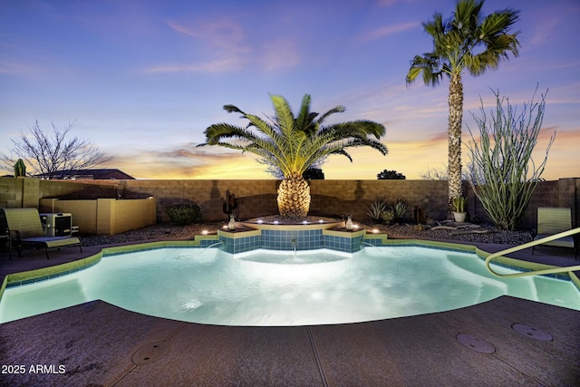 pool at dusk featuring a fenced backyard and a fenced in pool