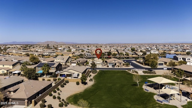 drone / aerial view featuring a residential view and a mountain view