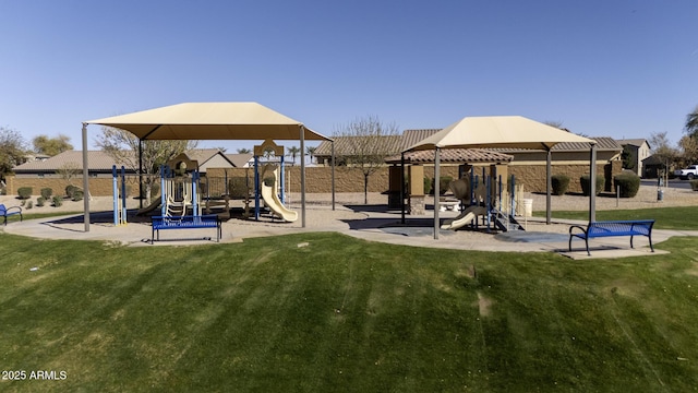 community jungle gym featuring a yard