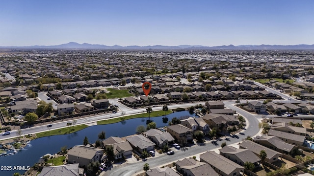 drone / aerial view featuring a residential view and a water and mountain view