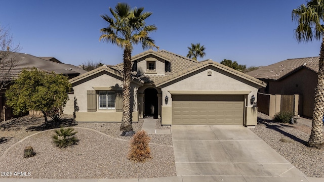 view of front of property with a garage, a tiled roof, driveway, and stucco siding