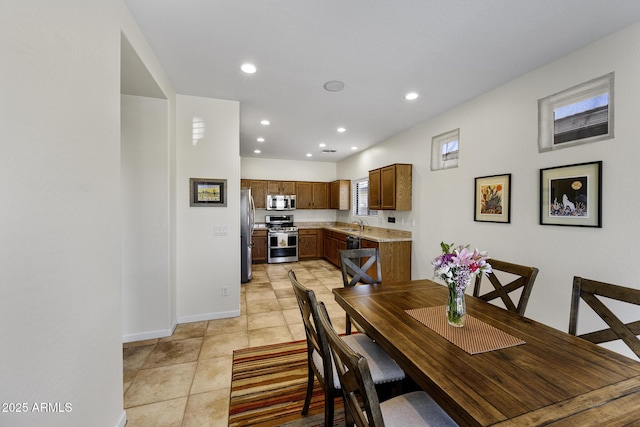 dining space with light tile patterned floors, baseboards, and recessed lighting