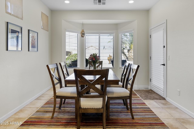 dining area featuring light tile patterned floors, a wealth of natural light, visible vents, and baseboards