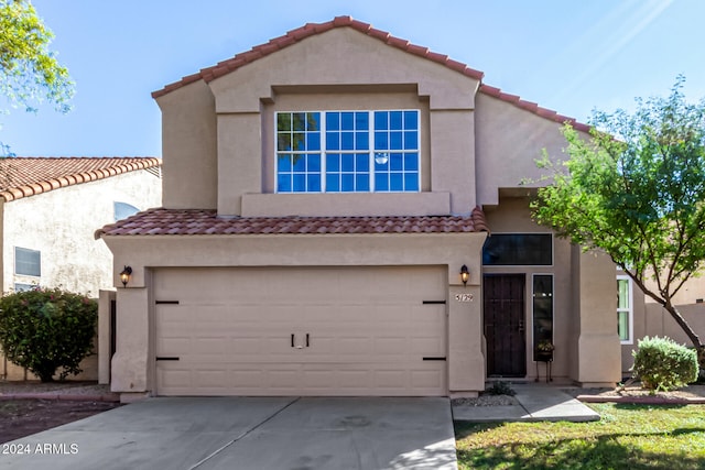 mediterranean / spanish-style house with a garage