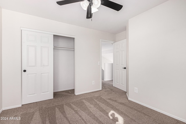 unfurnished bedroom with light colored carpet, a closet, and ceiling fan