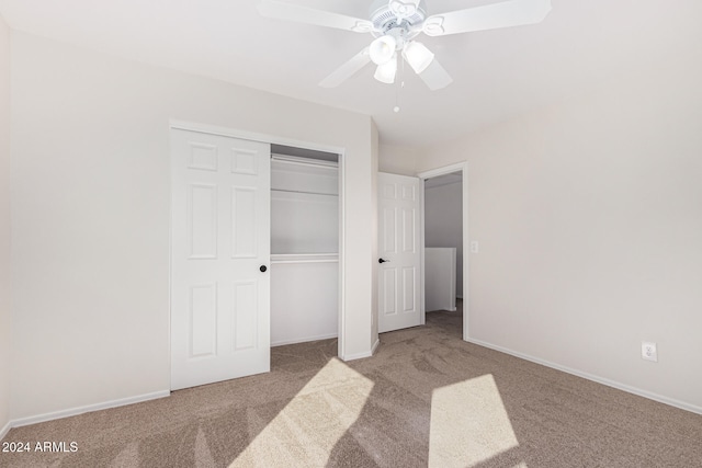 unfurnished bedroom featuring a closet, ceiling fan, and light colored carpet