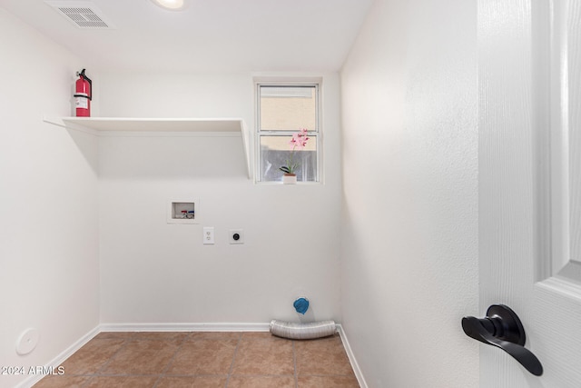 washroom featuring hookup for an electric dryer, light tile patterned flooring, and washer hookup