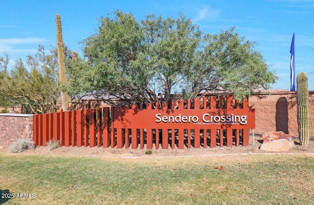 community / neighborhood sign with a yard