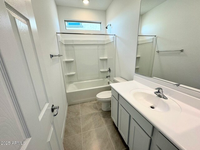 bathroom featuring tile patterned floors, shower / washtub combination, toilet, and vanity