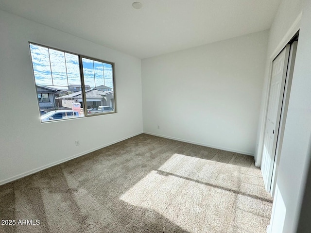 unfurnished bedroom with baseboards, a closet, and carpet floors