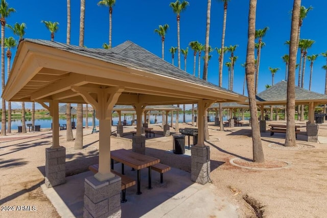 surrounding community with a gazebo and a water view